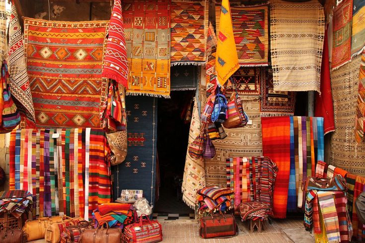 Busy market street in the Medina of Marrakech filled with colorful shops and people